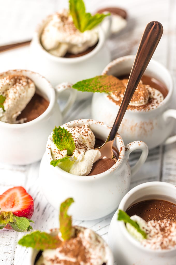 chocolate pots de creme topped with whipped cream and mint
