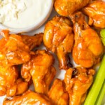 Baked Buffalo Wings are a tasty alternative to typical fried buffalo wings (and a bit healthier too!). These crispy baked chicken wings are covered in our homemade buffalo sauce for the perfect hot and spicy flavor. Baked Buffalo Chicken Wings are a real crowd pleaser and perfect for game day parties. You're going to love these crispy oven baked buffalo wings!
