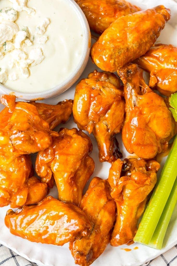 plate of buffalo wings with blue cheese and celery
