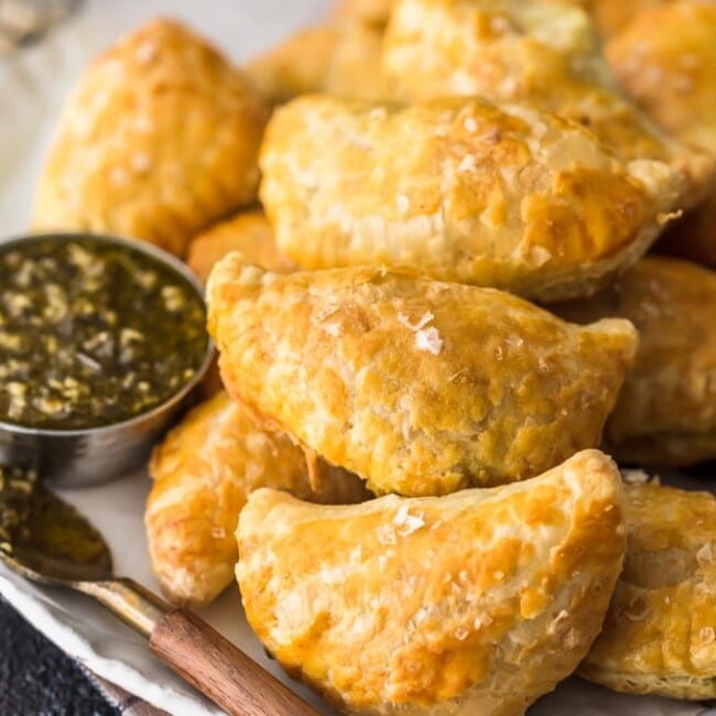 Curry Chicken Hand Pies are as easy as they are delicious! Game Day has never been more delicious than when you bring a batch of these Easy Chicken Curry Turnovers. These Curry Chicken Hand Pies are made with sliced chicken breast, frozen puff pastry dough, and a simple creamy chicken curry and vegetable filling; pleasing even the pickiest party guests. So much flavor!