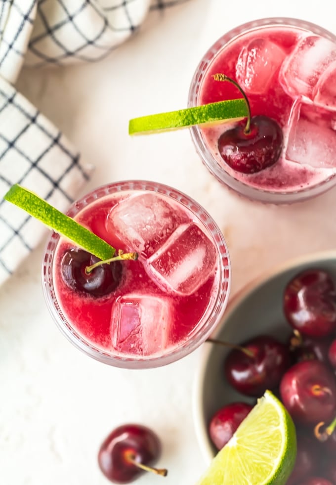 Refreshing cherry limeade recipe garnished with cherries and limes