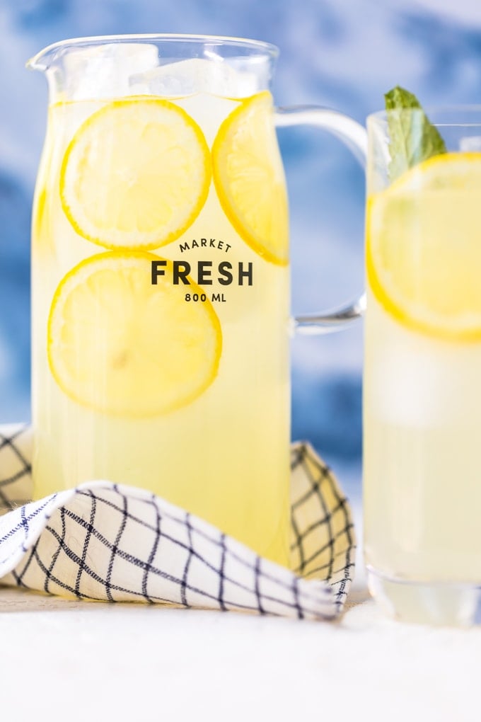 A pitcher of fresh squeezed lemonade with ice and lemon slices