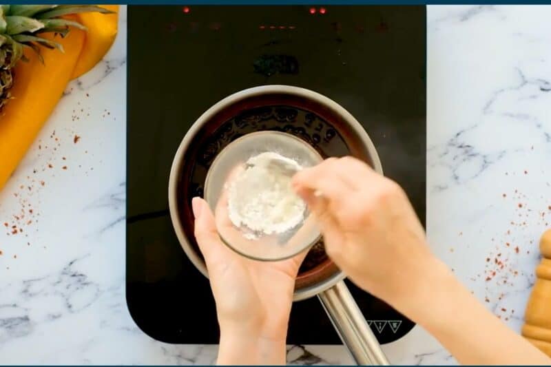 mixing cornstarch and water in a glass bowl