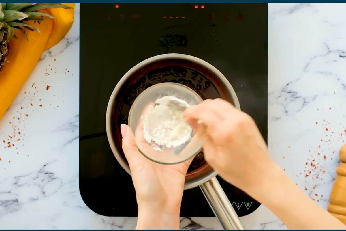 mixing cornstarch and water in a glass bowl