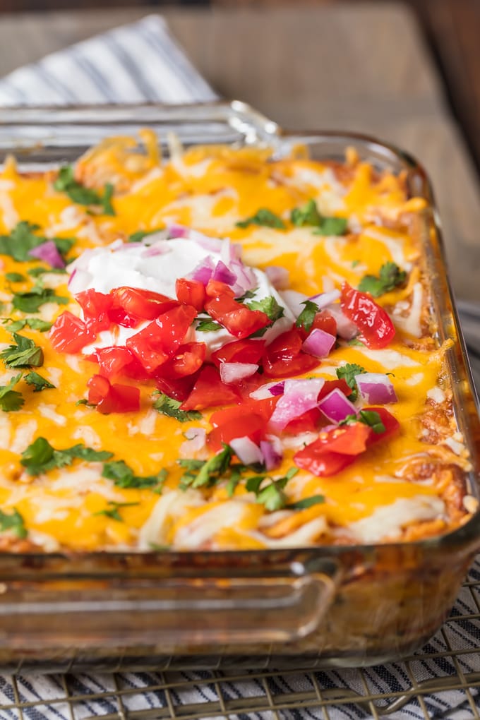 King Ranch Chicken Casserole topped with cheese, cilantro, tomatoes, onions, and sour cream