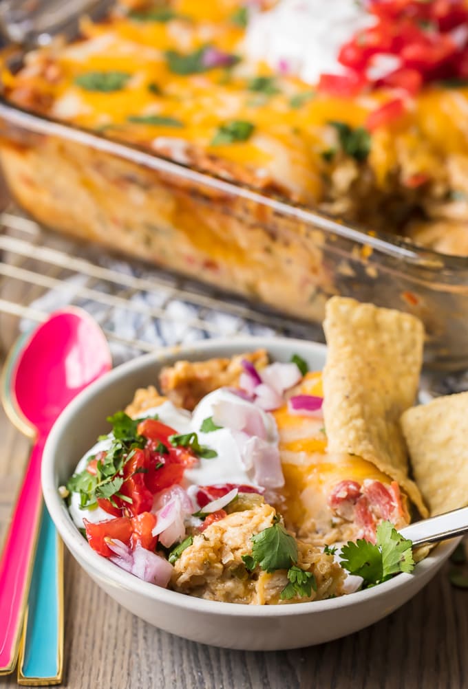 A bowl full of king ranch casserole, topped with sour cream and tortilla chips