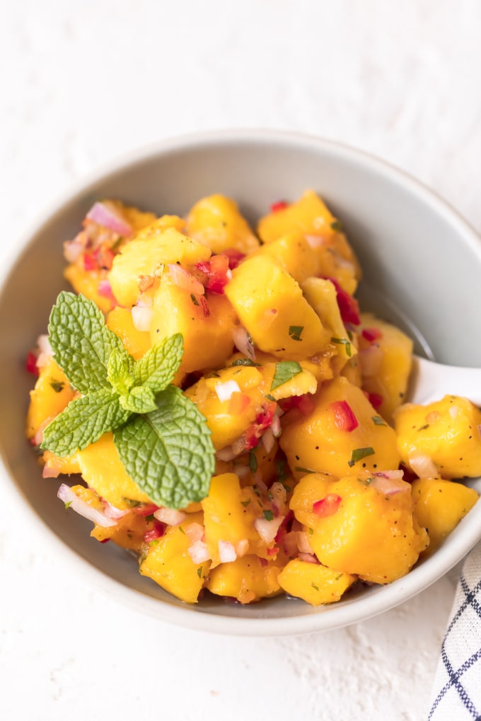 Small bowl of mango salsa, topped with mint