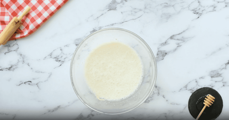 foamy milk in a glass bowl.