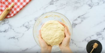 hands holding a ball of dough.