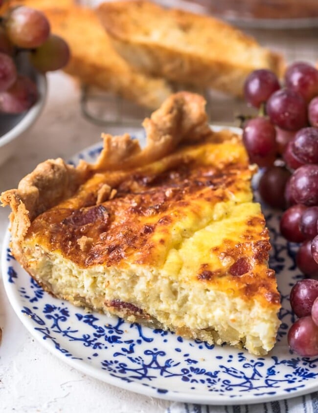 This Quiche Lorraine recipe is perfect for breakfast, brunch, or lunch. The pastry crust is filled with an egg & cream mixture full of bacon and cheese!