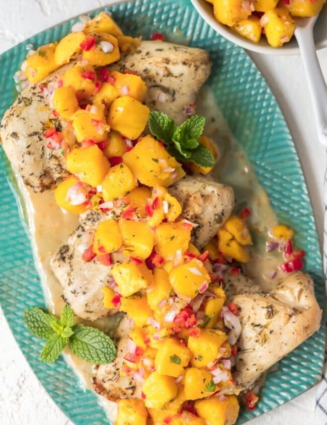 Sangria Chicken with Mango Salsa is a fresh and delicious dinner option. Combine a sangria butter sauce with marinated chicken breasts, and top it off fresh fruity mango salsa. The result is Mango Salsa Chicken, a tasty summer-time dish full of flavor!