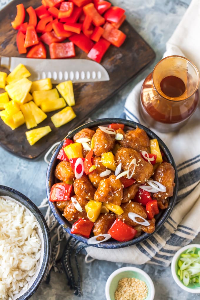 Sweet and sour chicken recipe next to chopped pineapple and sweet and sour sauce