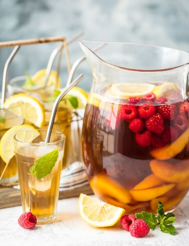 A bowl of fruit on a table, with Sangria
