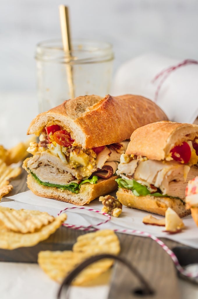 Sliced chicken breast and cobb salad on a sub sandwich