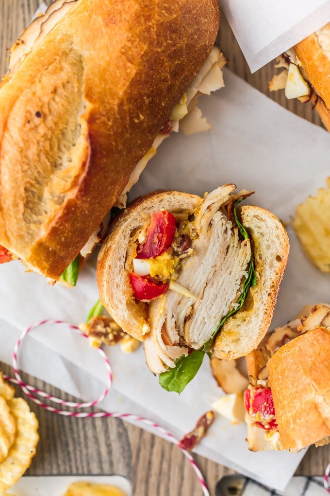 Sub sandwich layered with sliced teriyaki chicken breast, teriyaki dressing, and cobb salad mix