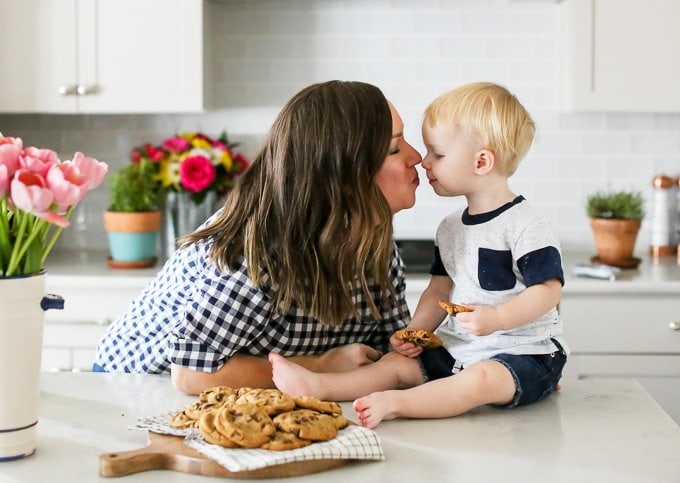 becky hardin with son on kitchen counter eating cookies