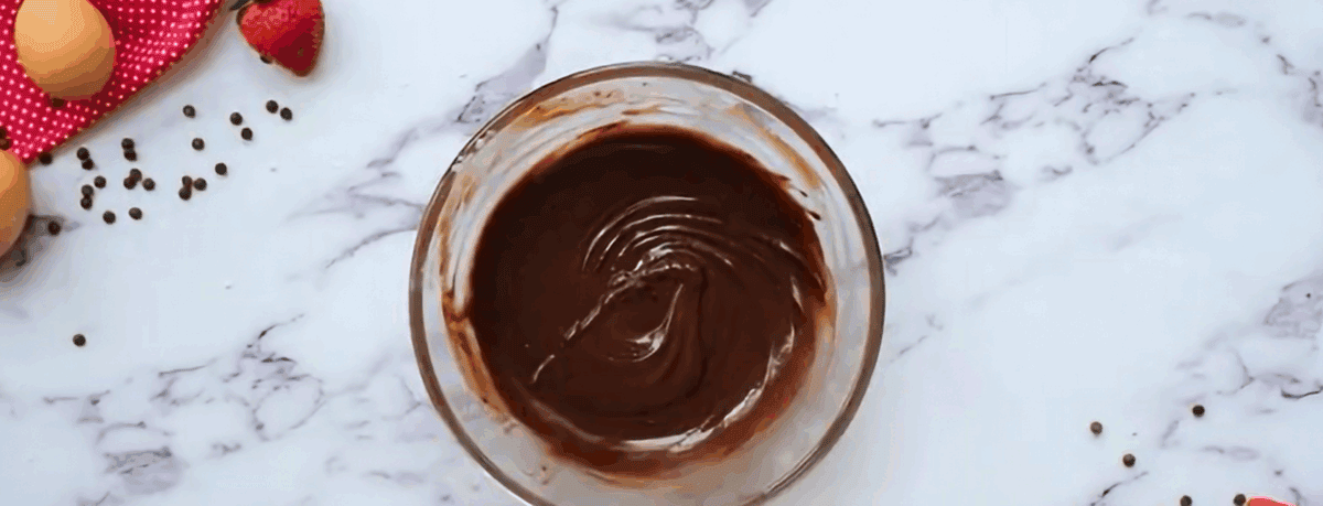Chocolate topping in a glass bowl.