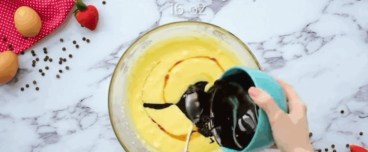 Adding vanilla and chocolate syrup to the egg mixture. 