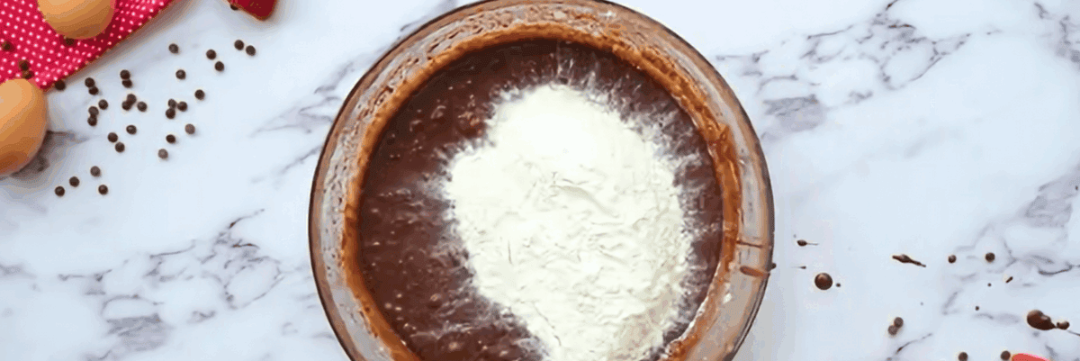 Adding flour mixture to chocolate mixture.