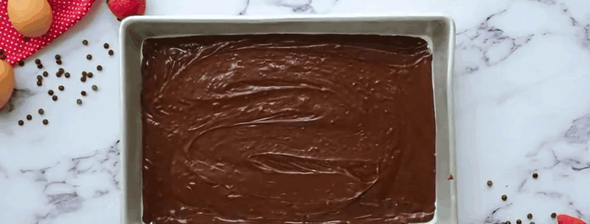Brownie batter in a metal baking pan.