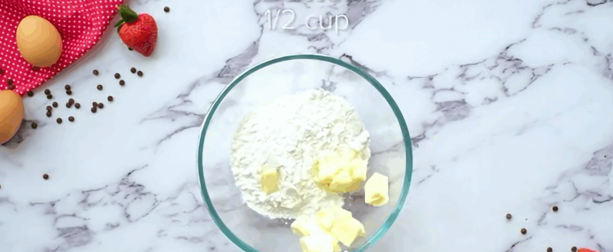 Combining butter and sugar in a glass bowl.