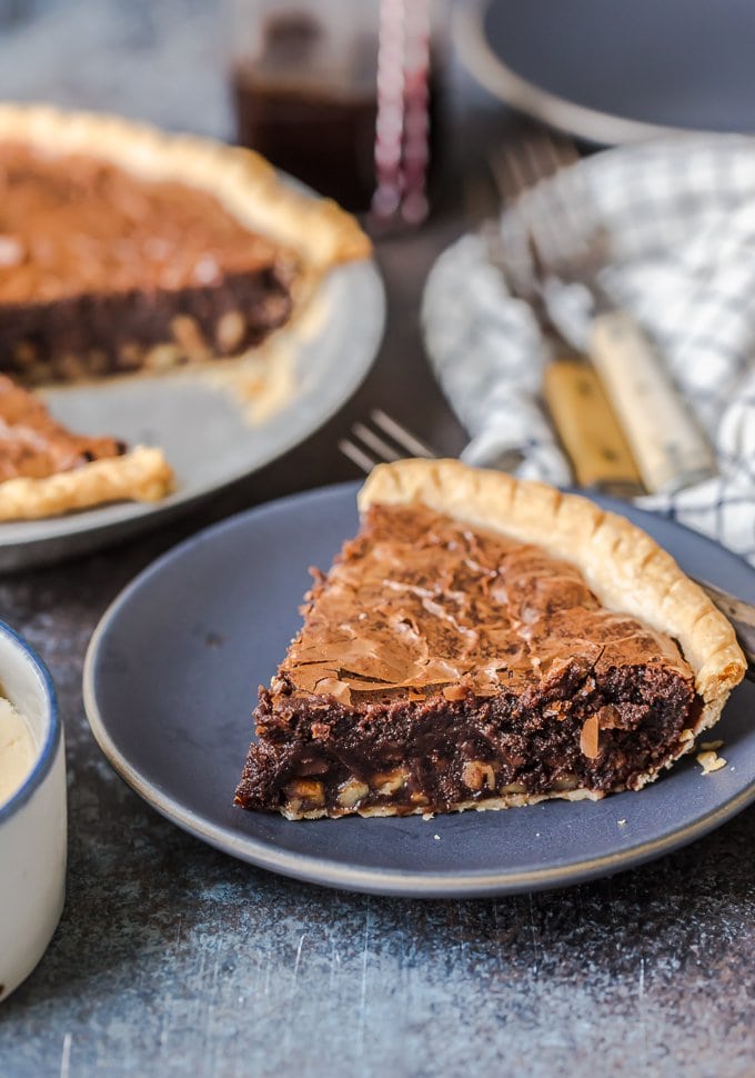 Brownie Pie is a rich, chocolaty dessert that's almost too good to be true! A homemade fudge brownie recipe baked straight into a pie crust gives you two desserts in one. A slice of fudge brownie pie on a plate