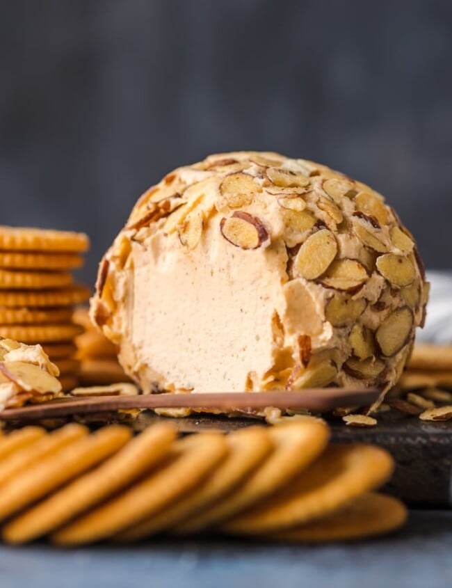 cheese ball on plate with crackers surrounding it