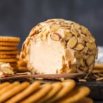 Almond cheese ball recipe with crackers on a cutting board.