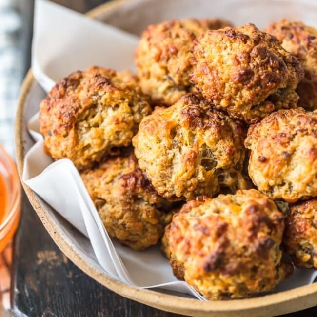 This classic Sausage Balls recipe is savory, cheesy, and tasty! These Bisquick sausage balls are the perfect appetizer for holidays or game day. Serve them with apricot sweet chili dipping sauce!