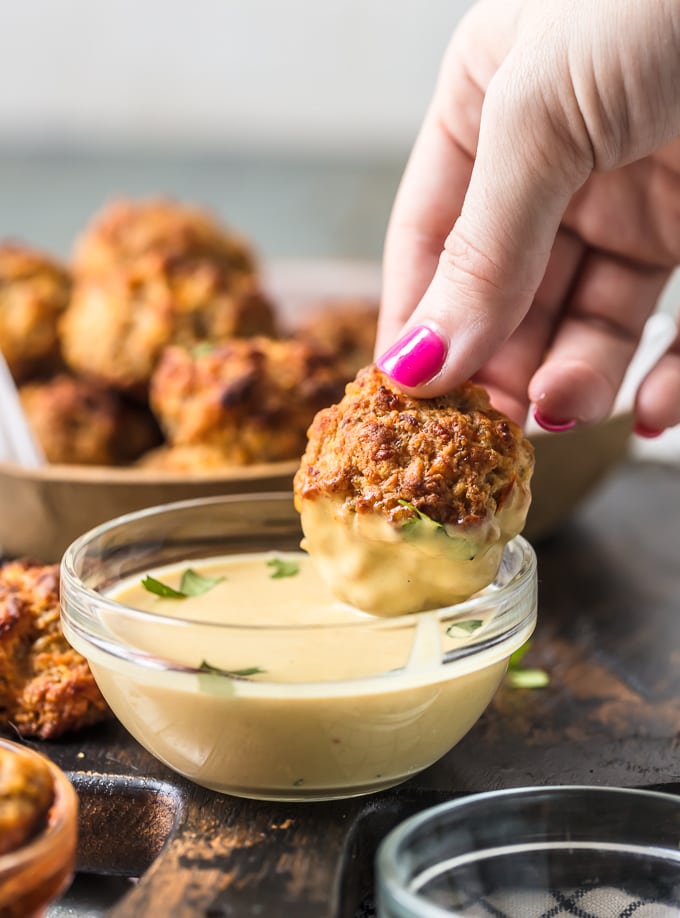 Sausage ball being dipped in sauce