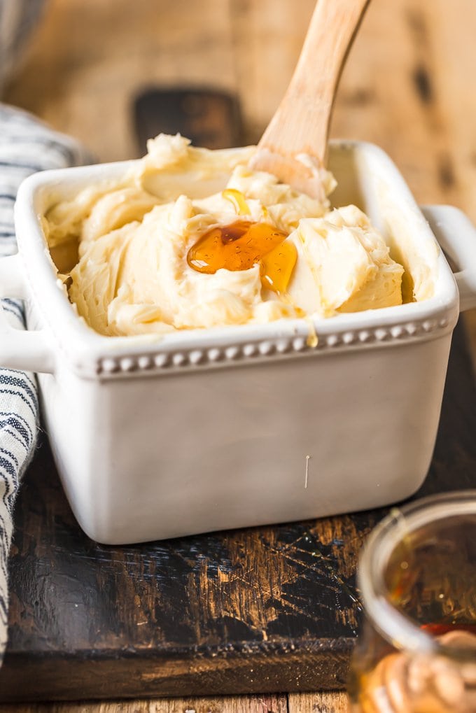 Container of butter with a puddle of honey sitting on top