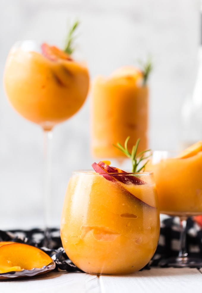 This Peach Frosé recipe is the perfect peachy summer cocktail! Frozen Rosé is icy, chill, and refreshing. Learn how to make frosé for all your summer occasions! Frozen Rose Recipe in different shape cups