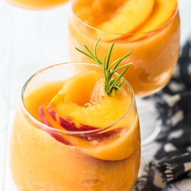 This Peach Frosé Recipe is a cocktail you definitely need for this hot Summer heat! All you need is frozen peaches, some Rosé wine, and a little honey. Frozen Rose is such a quick and easy fun cold drink to throw together for parties, friends and family, or just a quiet afternoon at home. We will show you how to make Frose and spice things up with this Peach Frose Recipe. So delicious, easy, fresh, and fun!