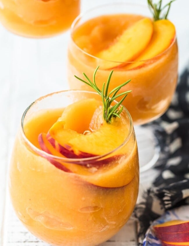 This Peach Frosé Recipe is a cocktail you definitely need for this hot Summer heat! All you need is frozen peaches, some Rosé wine, and a little honey. Frozen Rose is such a quick and easy fun cold drink to throw together for parties, friends and family, or just a quiet afternoon at home. We will show you how to make Frose and spice things up with this Peach Frose Recipe. So delicious, easy, fresh, and fun!