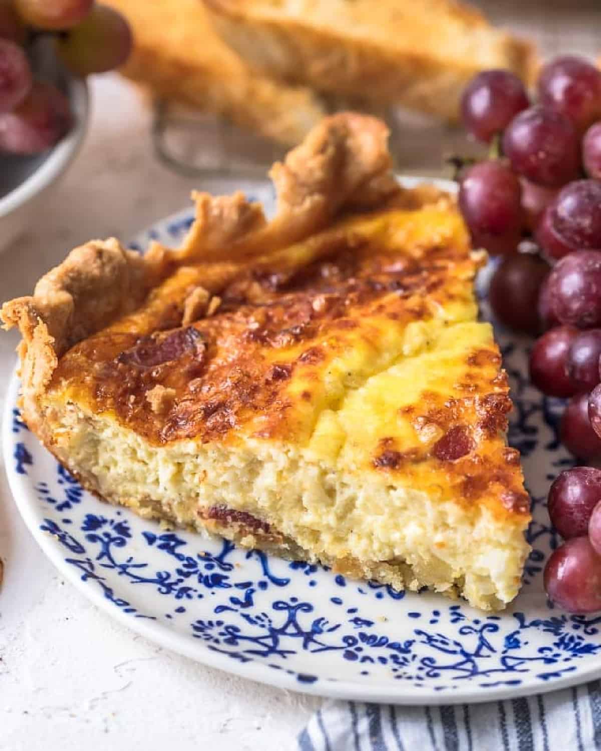 slice of quiche lorraine on a blue plate
