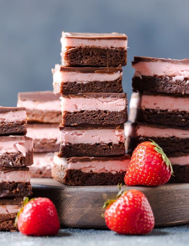 STRAWBERRY BROWNIES are perfect for Valentine's Day! This Chocolate Covered Strawberry Brownie Recipe is a mix of soft chocolate-y brownie, creamy strawberry filling, & a layer of melted chocolate.