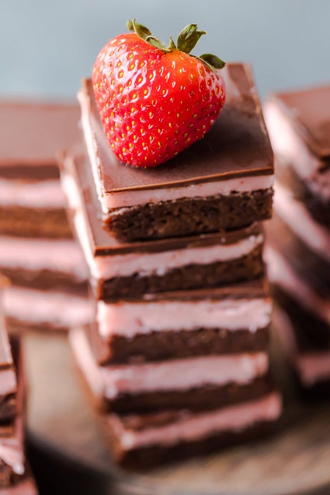 A stack of brownies with a strawberry on top