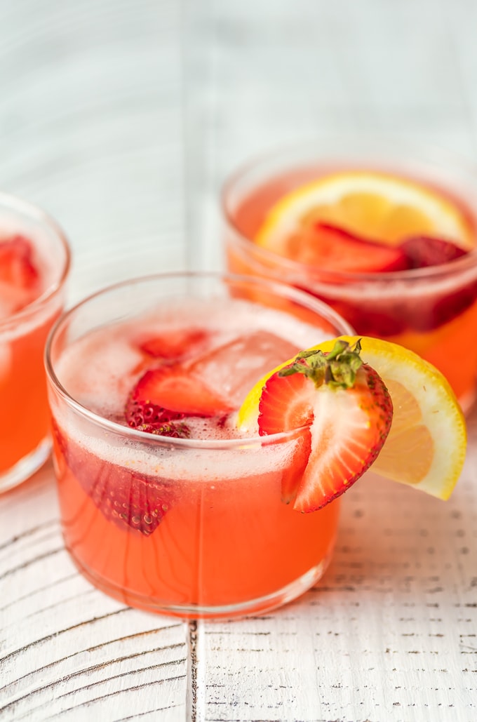 Strawberry Lemonade Party Punch is the best summer punch recipe! This refreshing drink is made with Everclear for the perfect party punch recipe. 3 glasses of strawberry lemonade summer punch