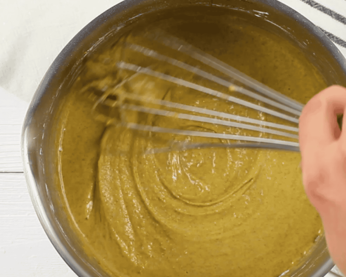 Combining ingredients to make the custard.