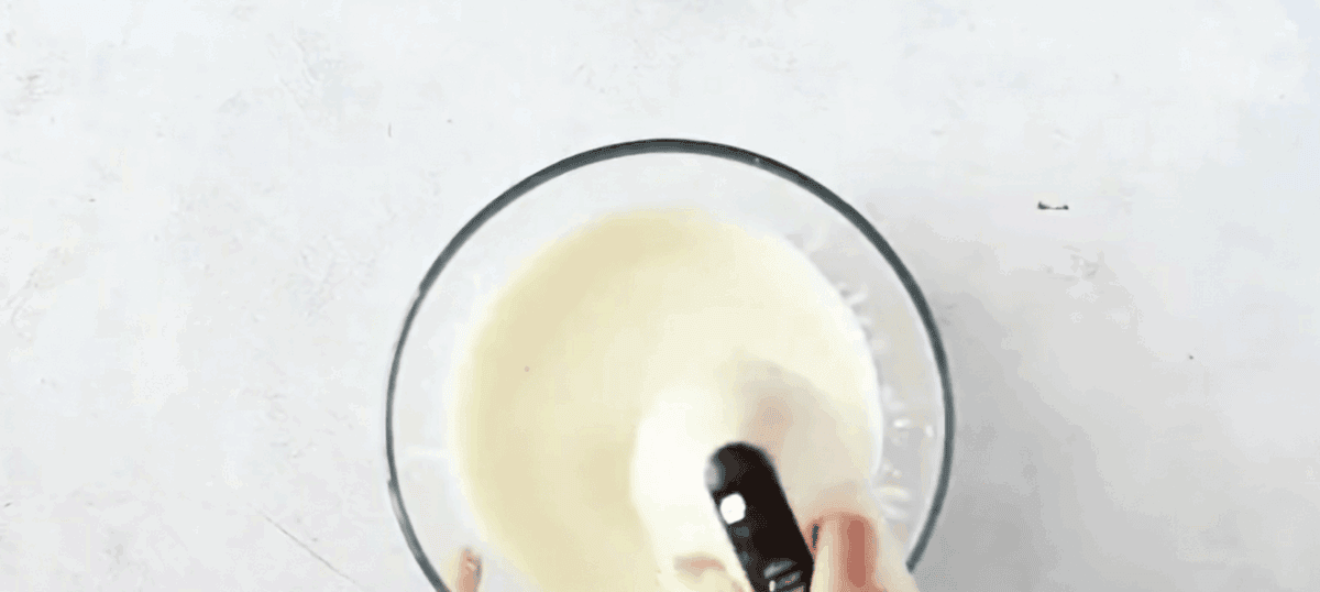 Using a hand blender to mix the cheese ingredients. 