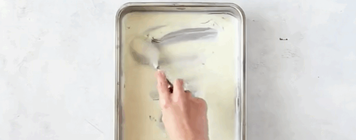 Spreading the cream cheese mixture into the bottom of the pan.