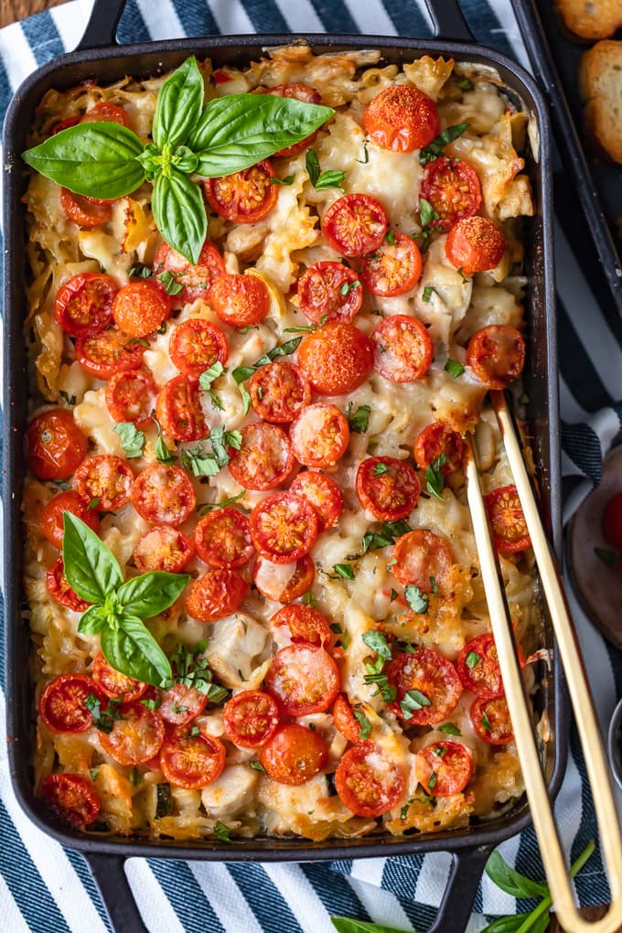 Chicken Alfredo Casserole topped with tomatoes and basil