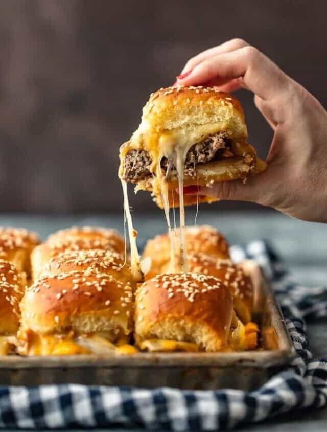 Baked Bacon Cheeseburger Sliders are a fun and easy lunch of dinner perfect for those busy school nights or fun game days! There's nothing better than this EASY Pull Apart Cheeseburger Slider Recipe for feeding a hungry crowd. So much cheese, so little time!