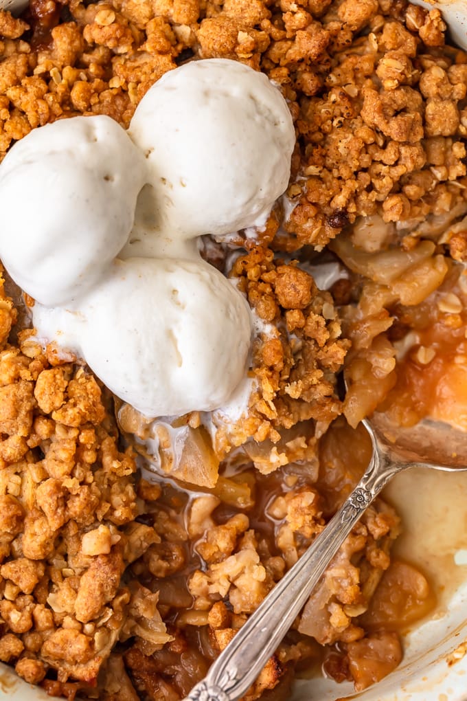 Homemade apple crisp topped with vanilla ice cream