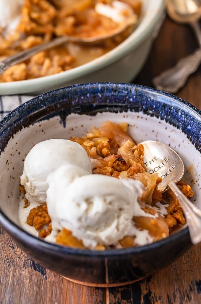 A bowl of homemade apple crisp topped with ice cream