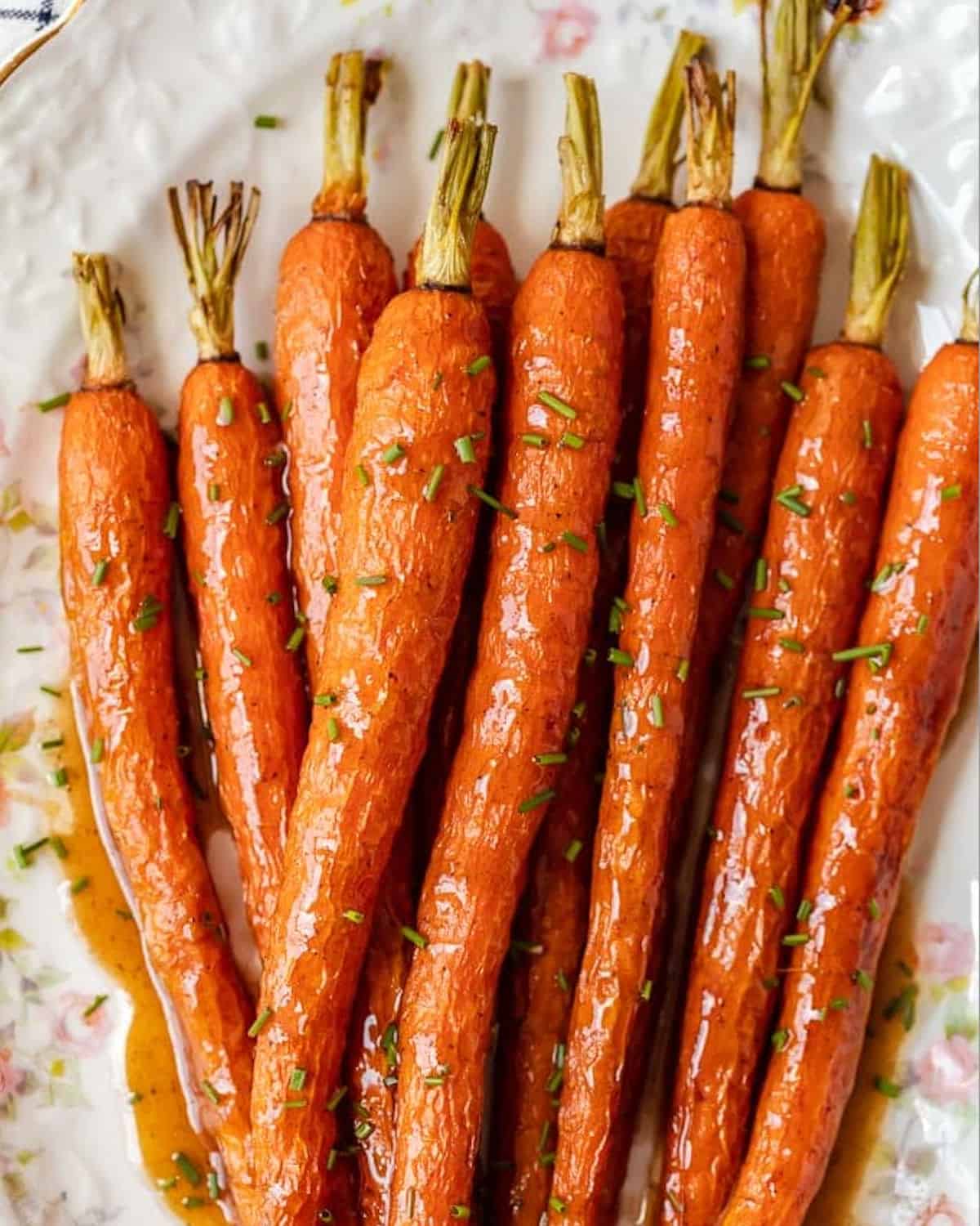 Honey glazed carrots on a white plate.