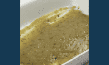 green mole sauce in a baking pan.