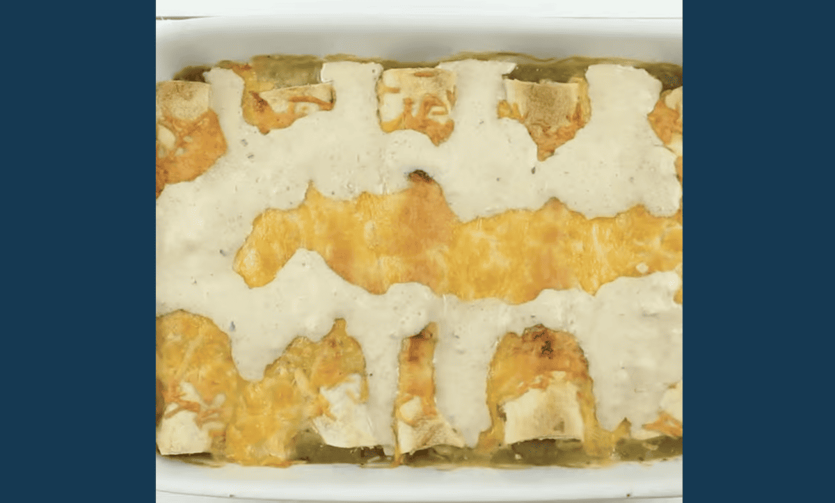 baked honey lime chicken enchiladas topped with cheese and sauce.