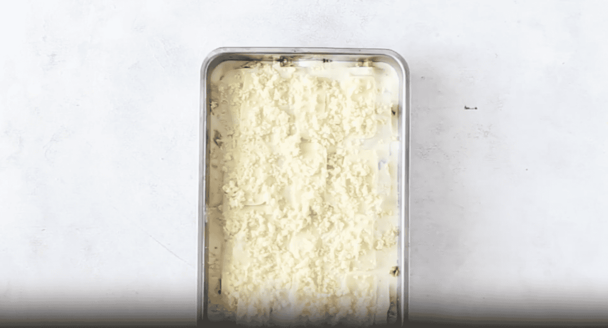 cheese topped lasagna in a baking pan.