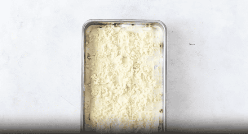 cheese topped lasagna in a baking pan.